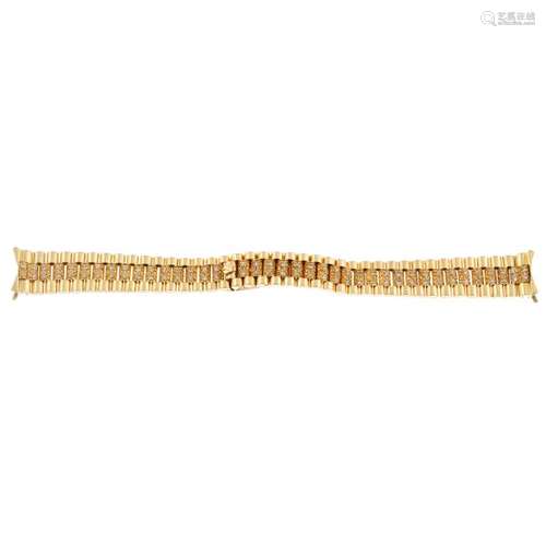 A yellow metal diamond set bracelet in the style of