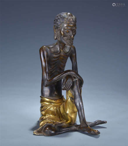 A COPPER GILT HUMAN FIGURE