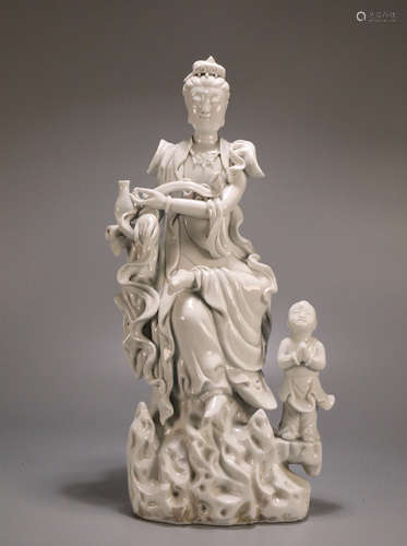 A GUANYIN AND BOY WHITE PORCELAIN FIGURE