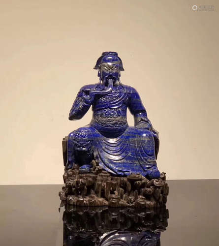 A LAPIS LAZULI GUANGONG FIGURE WITH WOOD HOLDER