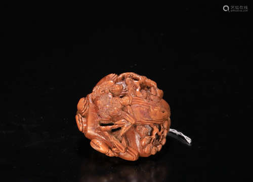 A NUT-PIT CARVED PENDANT