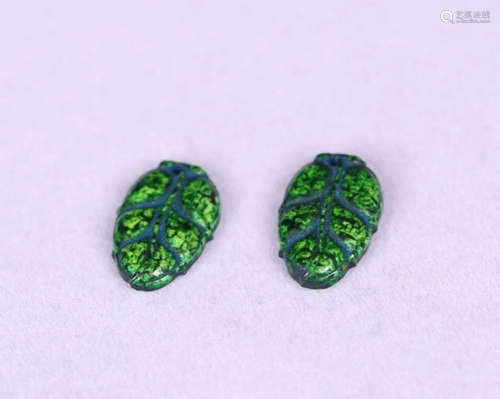 TWO QIUJIAO CARVED LEAF-SHAPED PENDANTS