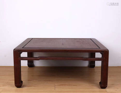 A RED WOOD BED TABLE