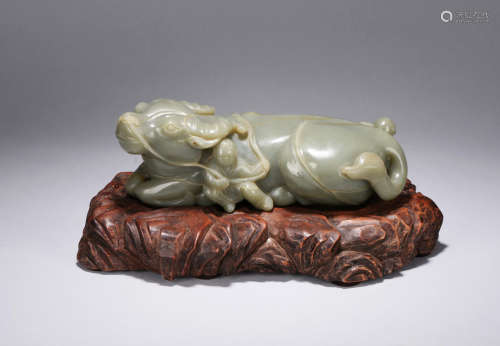 A CELADON JADE CARVING OF BUFFALO AND BOYS