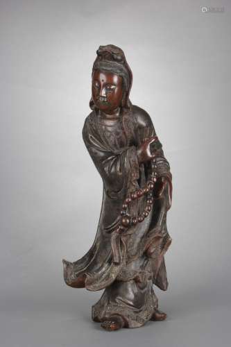 A ROSEWOOD CARVED STANDING GUANYIN FIGURE