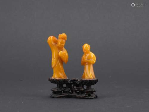 A BALTIC AMBER FIGURAL GROUP CARVING
