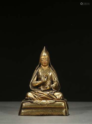 A GILT-BRONZE FIGURE OF LAMA