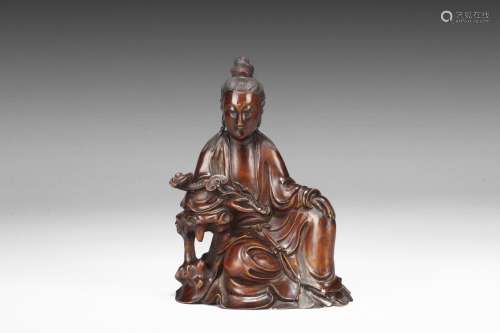 A HUANGHUALI CARVED FIGURE OF GUANYIN