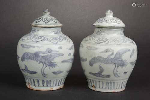 A PAIR OF BLUE AND WHITE 'CRANES' SMALL JARS WITH COVERS