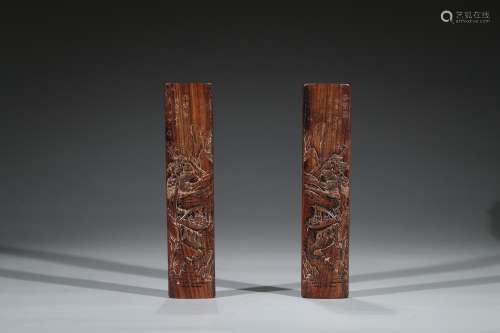 A PAIR OF ROSEWOOD CARVED 'RED CLIFF' WRIST RESTS