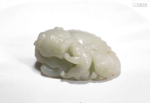 A WHITE JADE CARVING OF MYTHICAL LION AND CUB