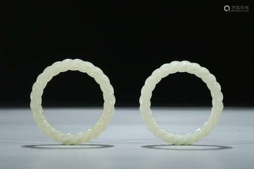 A PAIR OF ROPE-TWISTED WHITE JADE BANGLES