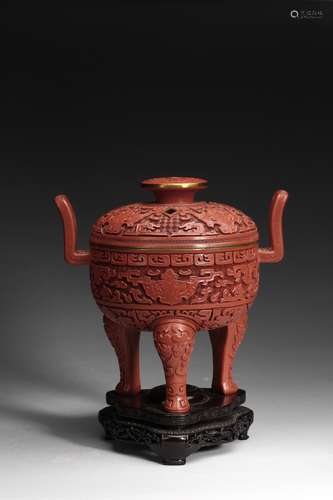 A CARVED CINNABAR LACQUER 'TAOTIE' TRIPOD CENSER AND COVER