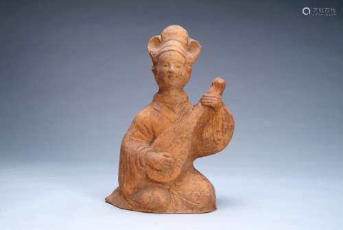 A POTTERY FIGURE OF A LADY