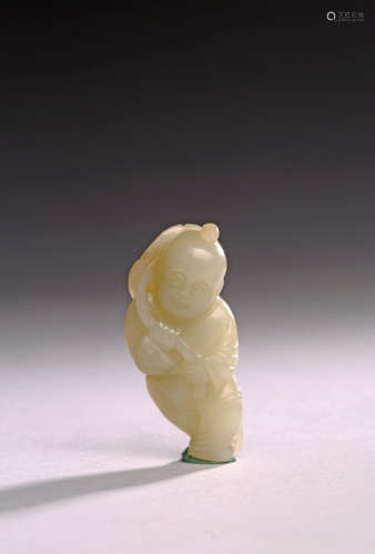 A WHITE JADE CARVING OF BOY HOLDING LOTUS