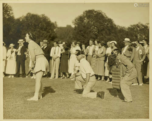 Silver Gelatin Print, 195 x 295 mm, an image of a young woman at bat, with a male umpire and catcher behind her, WOMEN'S BASEBALL.