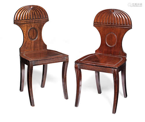 A near pair of Regency mahogany hall chairs