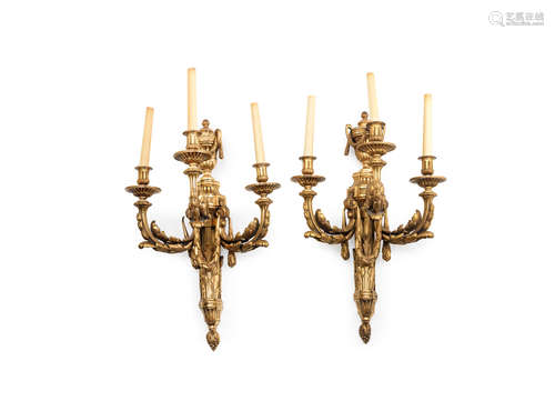 in the Louis XVI style A pair of large gilt bronze three light wall appliques