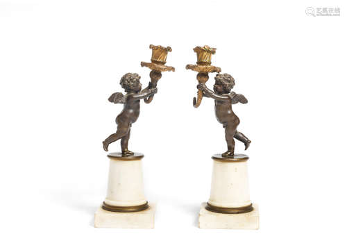 A pair of early 19th century gilt and patined bronze and white marble figural candlesticks (2)