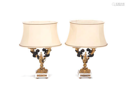 in the Louis XVI style A pair of gilt and patinated bronze twin light garniture candelabra lampbases