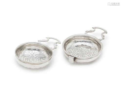 the first by William Justis, London circa 1730; the second by William Bird, London circa 1740  (2) Two George II silver lemon strainers