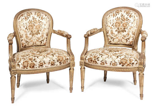 in the Louis XVI style A pair of French late 19th century carved giltwood fauteuils by Jansen