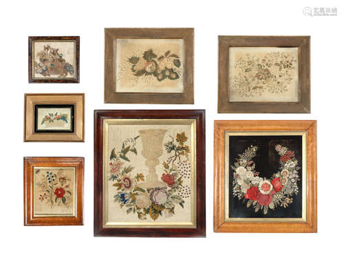 A collection of seven late 18th and 19th century silk and wool embroidered and cut felt and velvet pictures depicting various floral and fruit subjects