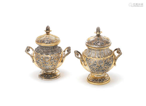 stamped 'FATTO A MANO',  one with post 1968 period marks for Como, stamped '800', the other only stamped '925'  A matched pair of Italian metalware and gilded pots and covers