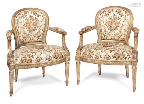 in the Louis XVI style A pair of French late 19th century carved giltwood fauteuils by Jansen