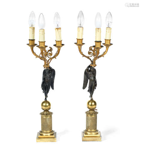 in the Empire taste  A pair of 19th century French gilt and patinated bronze figural three light candleabra