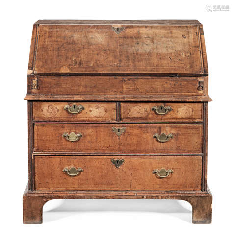 A George I walnut and featherbanded bureau of small proportions