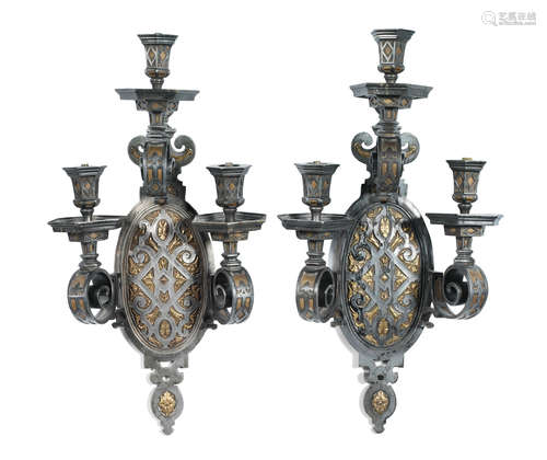 in the 17th century style A pair of unusual late 19th / early 20th century French silvered and gilt metal three light wall appliques