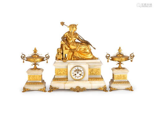 A late 19th century French gilt bronze and cream onyx Egyptian revival figural mantel clock garniture