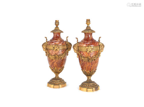 in the Louis XVI style A pair of late 19th / early 20th century French gilt bronze mounted variegated red-brown marble pedestal vase lampbases