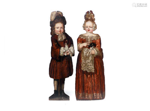 probably early 18th century, perhaps with refreshed painted faces, the remaining decoration of a later date A pair of painted pine dummy boards of children holding small dogs