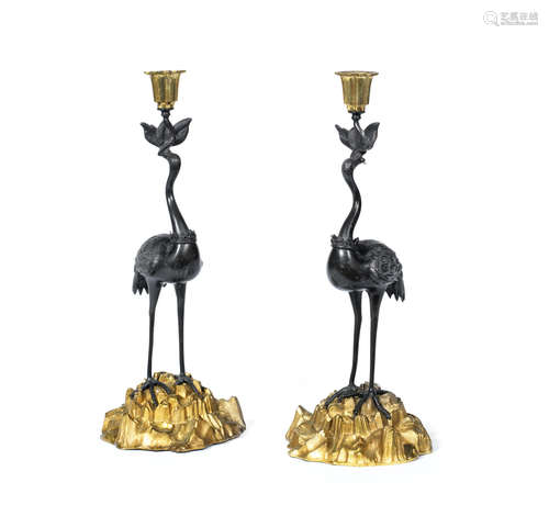 in the manner of Thomas Abbott A pair of mid 19th century gilt and patinated bronze crane candlesticks