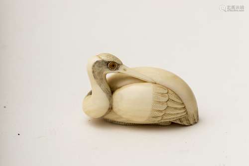 Katabori netsuke, crane, Japan, Meiji period Ivory, featuring a crane preening itself. Signed under