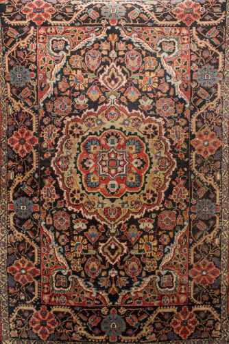 Rug Wool with black background and polychrome floral décor. Antique tag on the back. - 198 x 132 cm