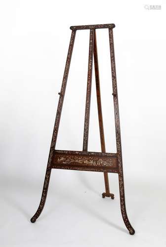 An early 20th Century Chinese style mahogany easel, inlaid and decorated with bone, the rear stand