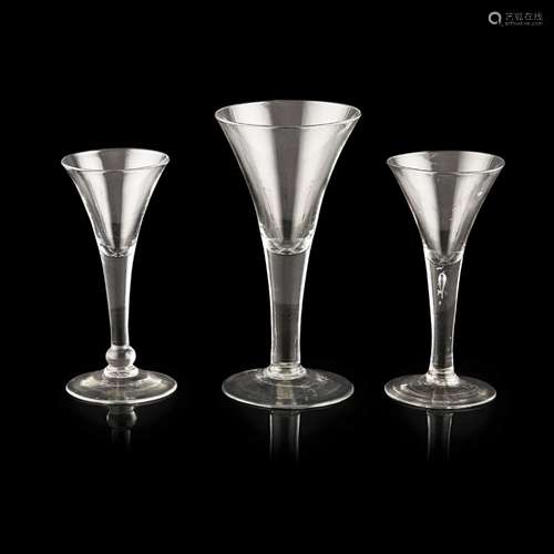 GROUP OF THREE GEORGIAN WINE GLASSESMID-18TH CENTURY each with plain flared trumpet-form bowls,