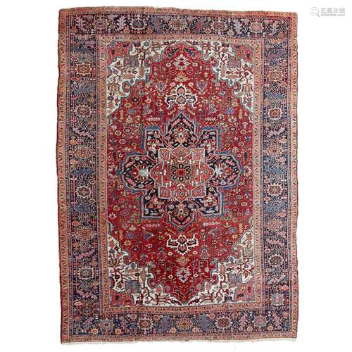 HERIZ CARPETNORTHWEST PERSIA, EARLY 20TH CENTURY the red field with indigo and red medallion,