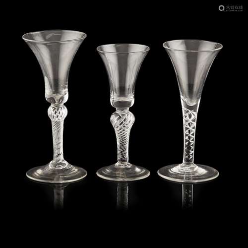 THREE GEORGIAN TWIST STEM WINE GLASSESMID-18TH CENTURY all with flared trumpet or bell bowls,