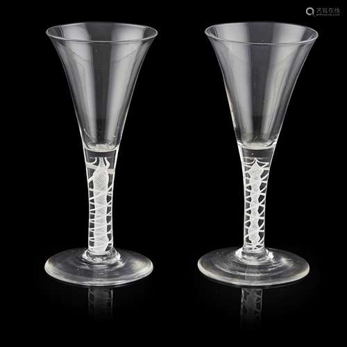 PAIR OF GEORGIAN OPAQUE TWIST STEMMED WINE GOBLETSCIRCA 1760 with large trumpet bowls, raised on