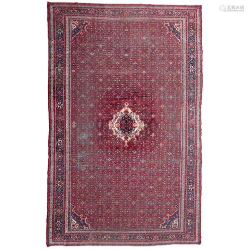 BAKHTIARI CARPETWEST PERSIA, MID 20TH CENTURY the red field with small ivory and indigo medallion,