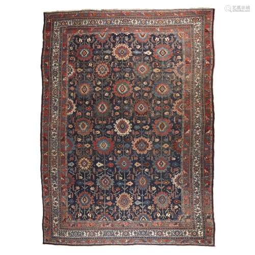 NORTH WEST PERSIAN CARPETLATE 19TH/EARLY 20TH CENTURY the indigo field with allover stylised