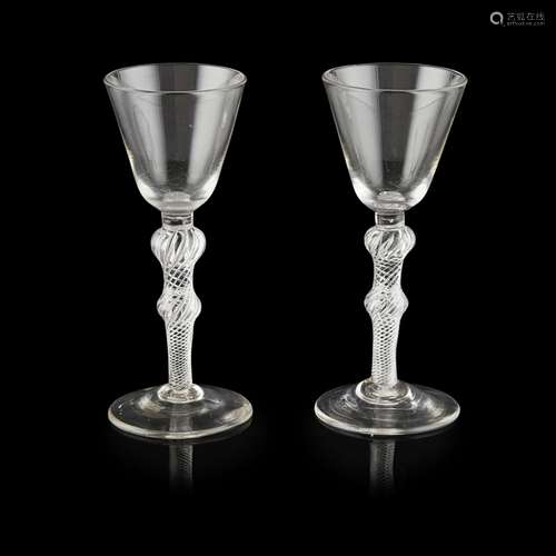 PAIR OF GEORGIAN AIR TWIST STEMMED WINE GLASSESCIRCA 1750 with rounded funnel bowls raised on