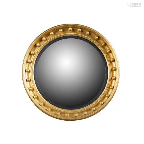 REGENCY GILTWOOD CONVEX MIRROREARLY 19TH CENTURY the circular mirror plate in an ebonised slip and