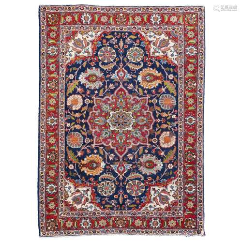 TABRIZ RUGNORTHWEST PERSIA, MID 20TH CENTURY the indigo field with red and cream medallion, cream