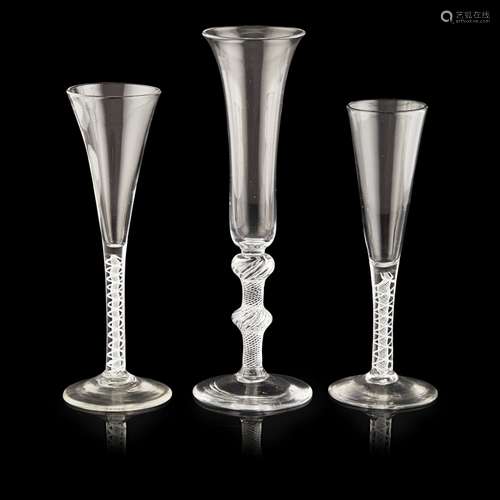 GROUP OF THREE GEORGIAN GLASS FLUTESMID-18TH CENTURY comprising two wine flutes with tapered bowls