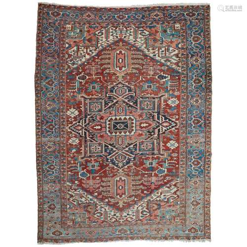 HERIZ CARPETNORTHWEST PERSIA, LATE 19TH/EARLY 20TH CENTURY the brick red field with indigo and